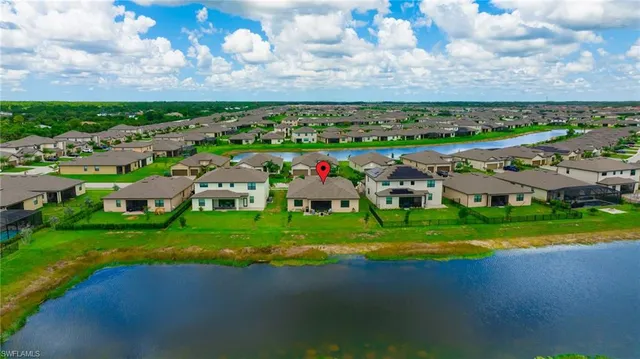 an aerial view of a houses with outdoor space and tennis court