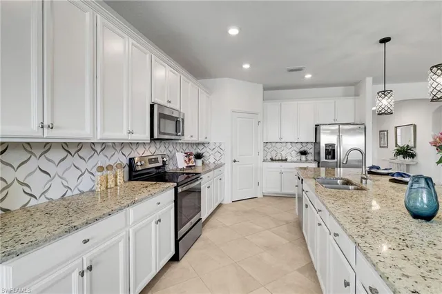 a large kitchen with stainless steel appliances granite countertop a stove sink microwave and cabinets