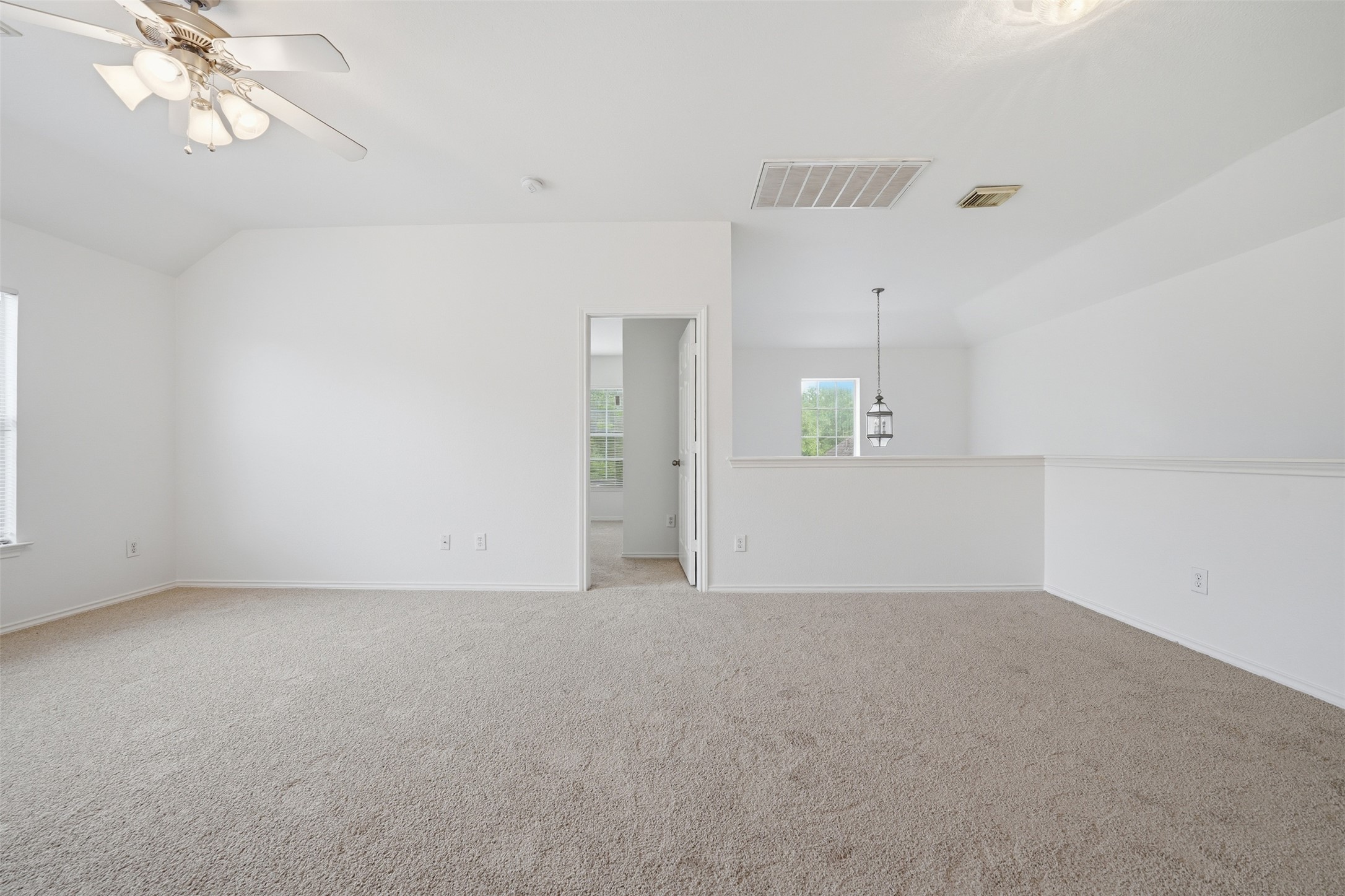 118 Invierno Street Kyle, TX 78640 - Photo 25 of 37 A spacious, naturally illuminated loft area offers comfort and versatile living.