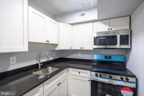 a kitchen with a refrigerator and cabinets