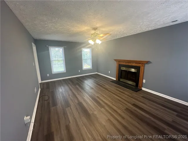 a view of a livingroom with wooden floor and chandelier