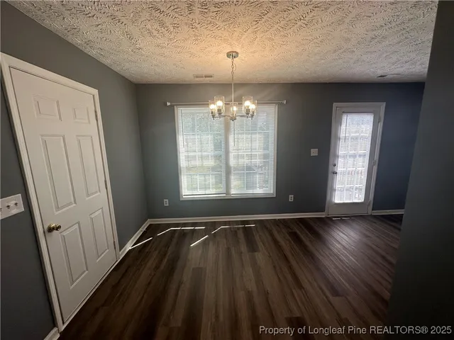 a kitchen with a refrigerator a sink and wooden floor
