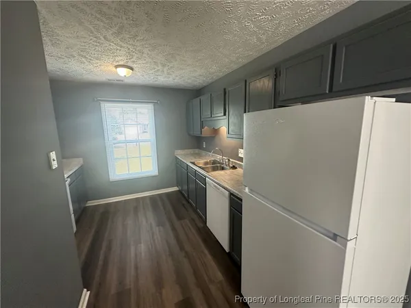 a view of a kitchen with a sink and a stove