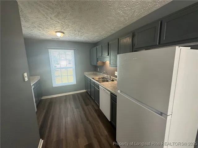 a view of a kitchen with a sink and a stove