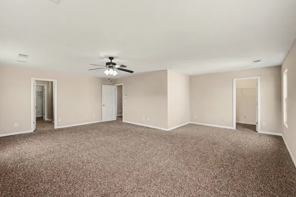 a view of an empty room with a ceiling fan