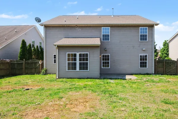 a brick house with a yard in front of it