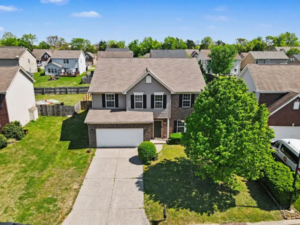 a aerial view of a house with a yard and plants