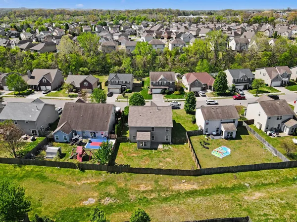 an aerial view of house with yard swimming pool and outdoor seating