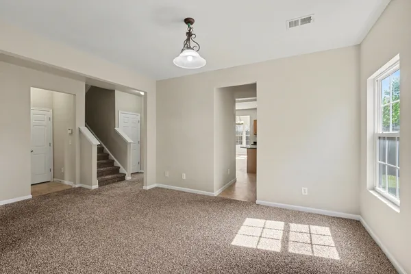 a view of an empty room with windows