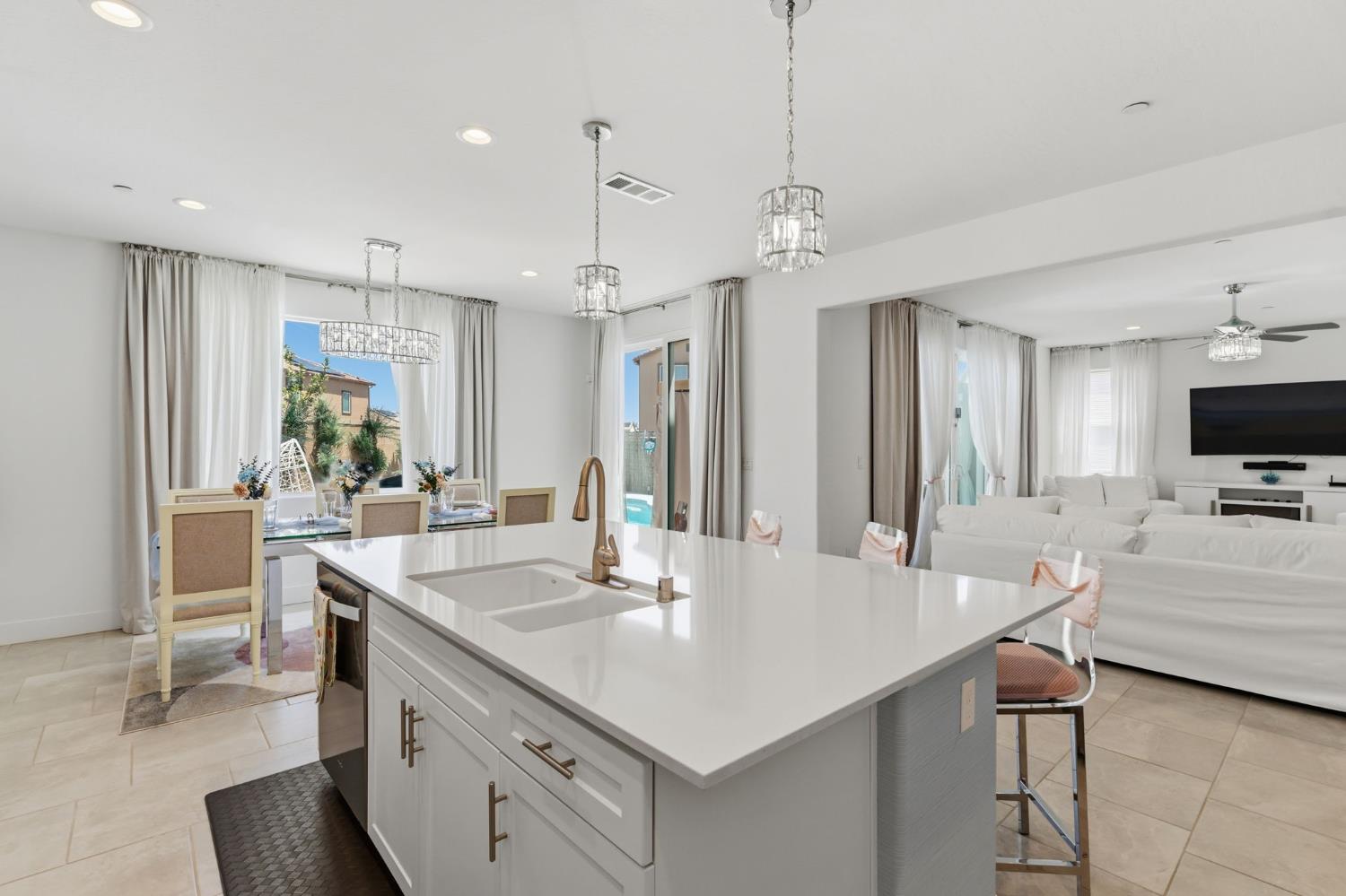 6326 West Richert Avenue Fresno, CA 93723 - Photo 10 of 45 a large kitchen with kitchen island a sink table and chairs