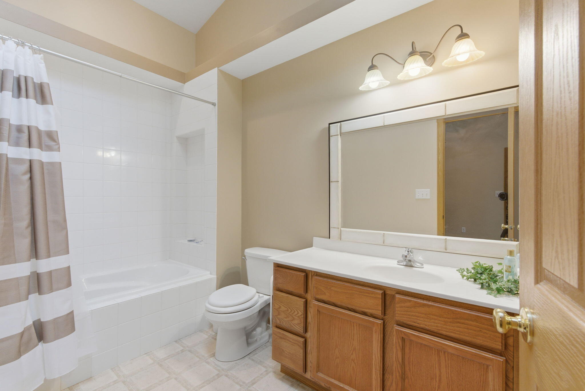 829 Johnson Street, Unit A Porter, IN 46304 - Photo 11 of 21 a bathroom with a double vanity sink toilet mirror and bathtub