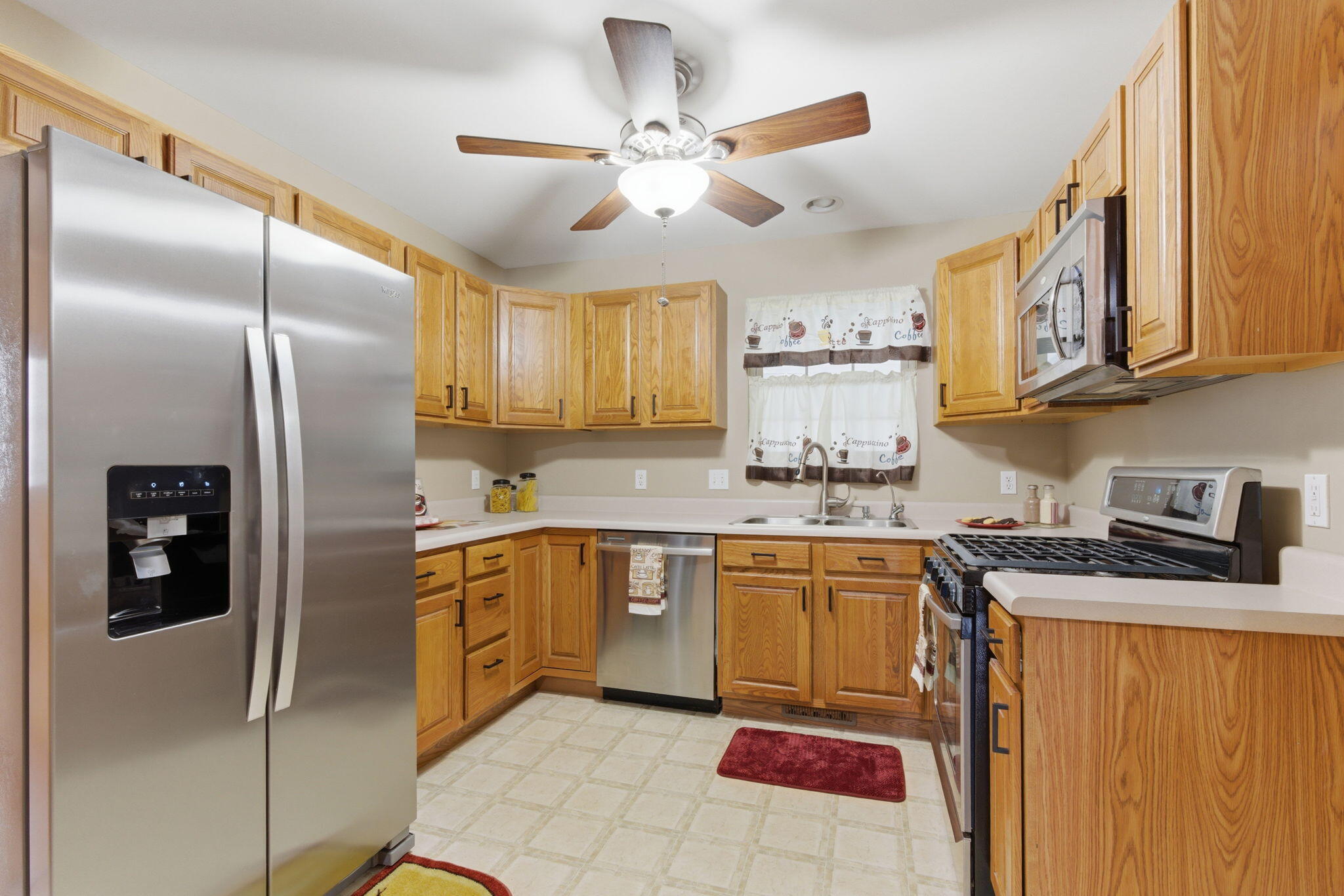 829 Johnson Street, Unit A Porter, IN 46304 - Photo 12 of 21 a kitchen with stainless steel appliances granite countertop a refrigerator a stove and a sink