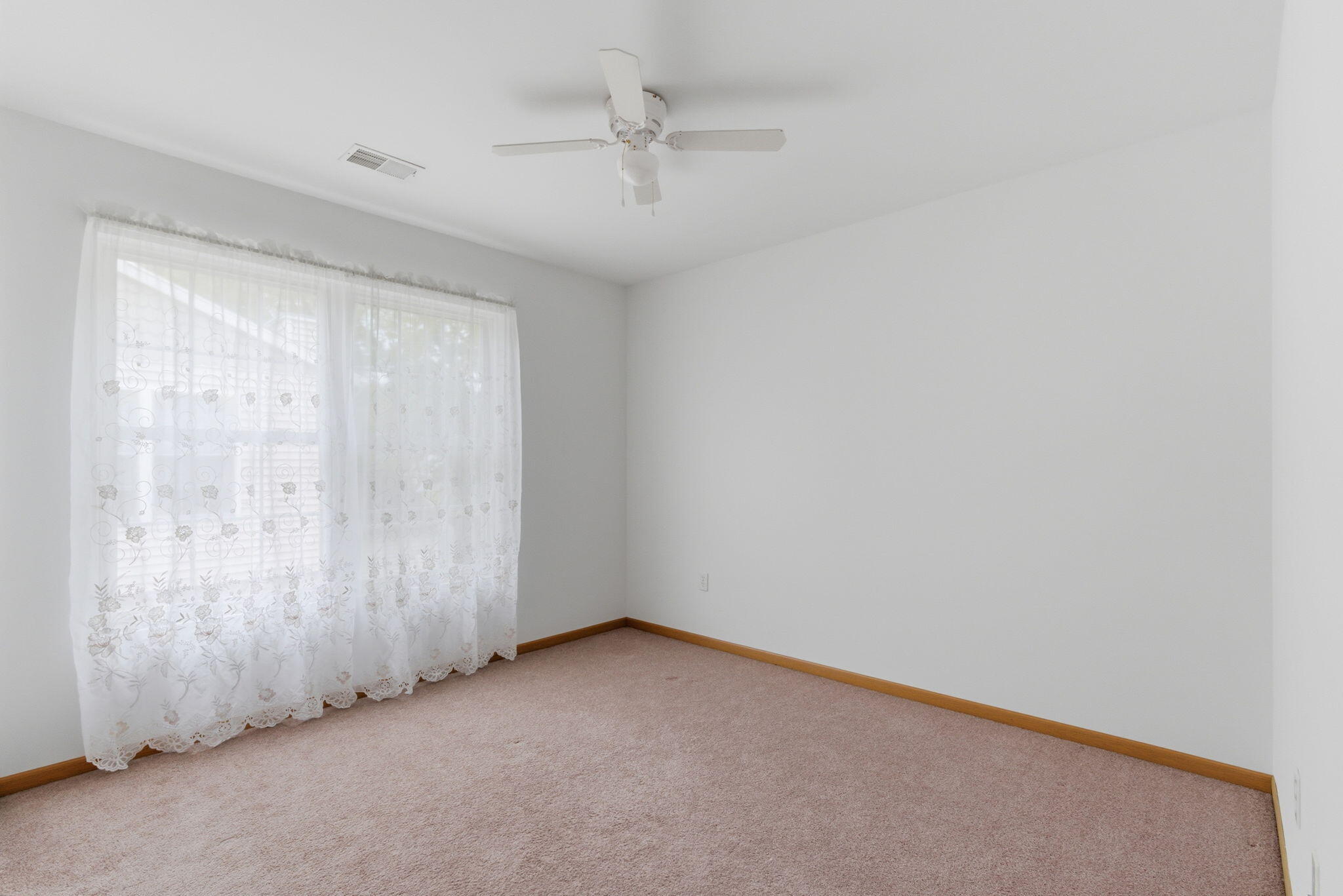 829 Johnson Street, Unit A Porter, IN 46304 - Photo 15 of 21 an empty room with a ceiling fan and window
