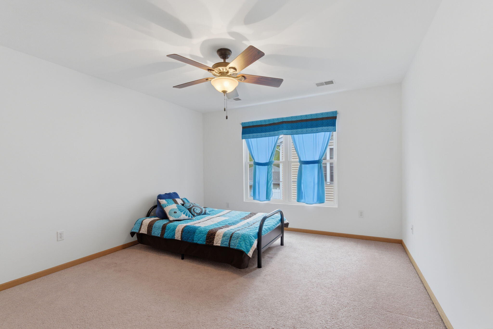 829 Johnson Street, Unit A Porter, IN 46304 - Photo 19 of 21 a room with a bed and a chandelier fan