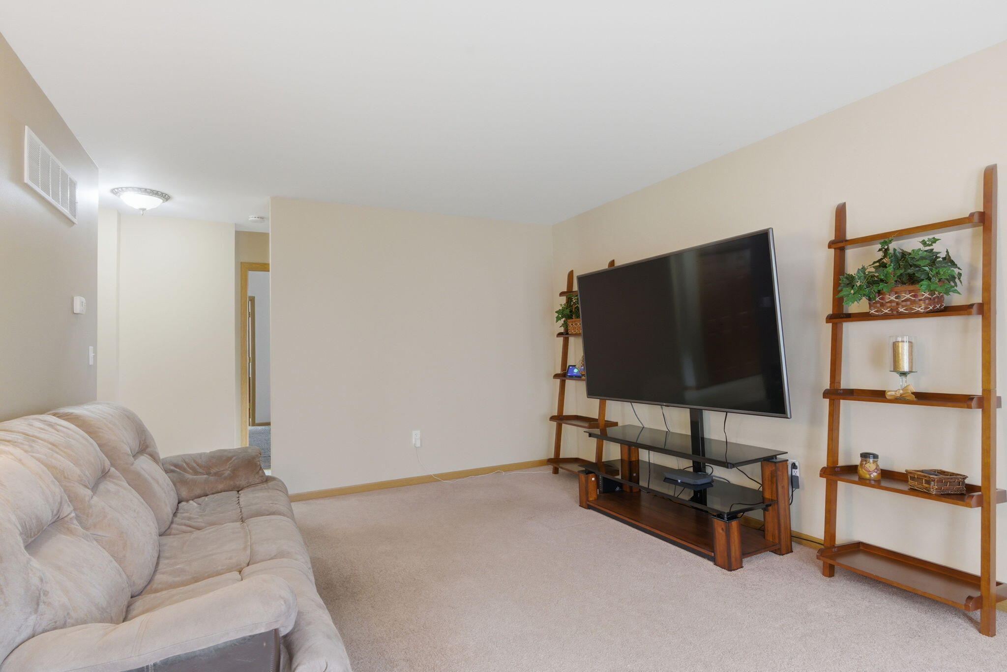 829 Johnson Street, Unit A Porter, IN 46304 - Photo 6 of 21 a living room with furniture and a flat screen tv
