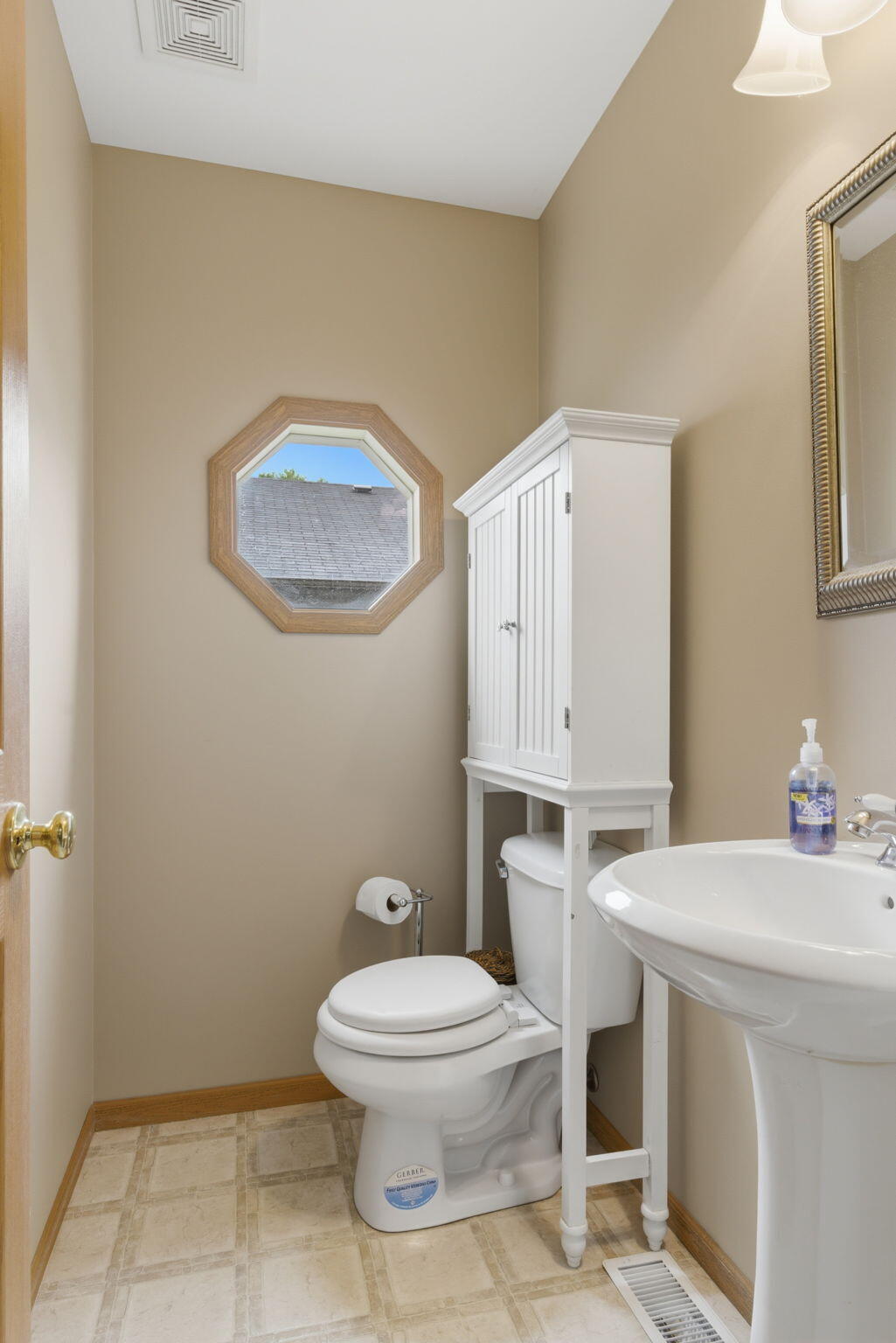 829 Johnson Street, Unit A Porter, IN 46304 - Photo 8 of 21 a bathroom with a toilet a sink and mirror
