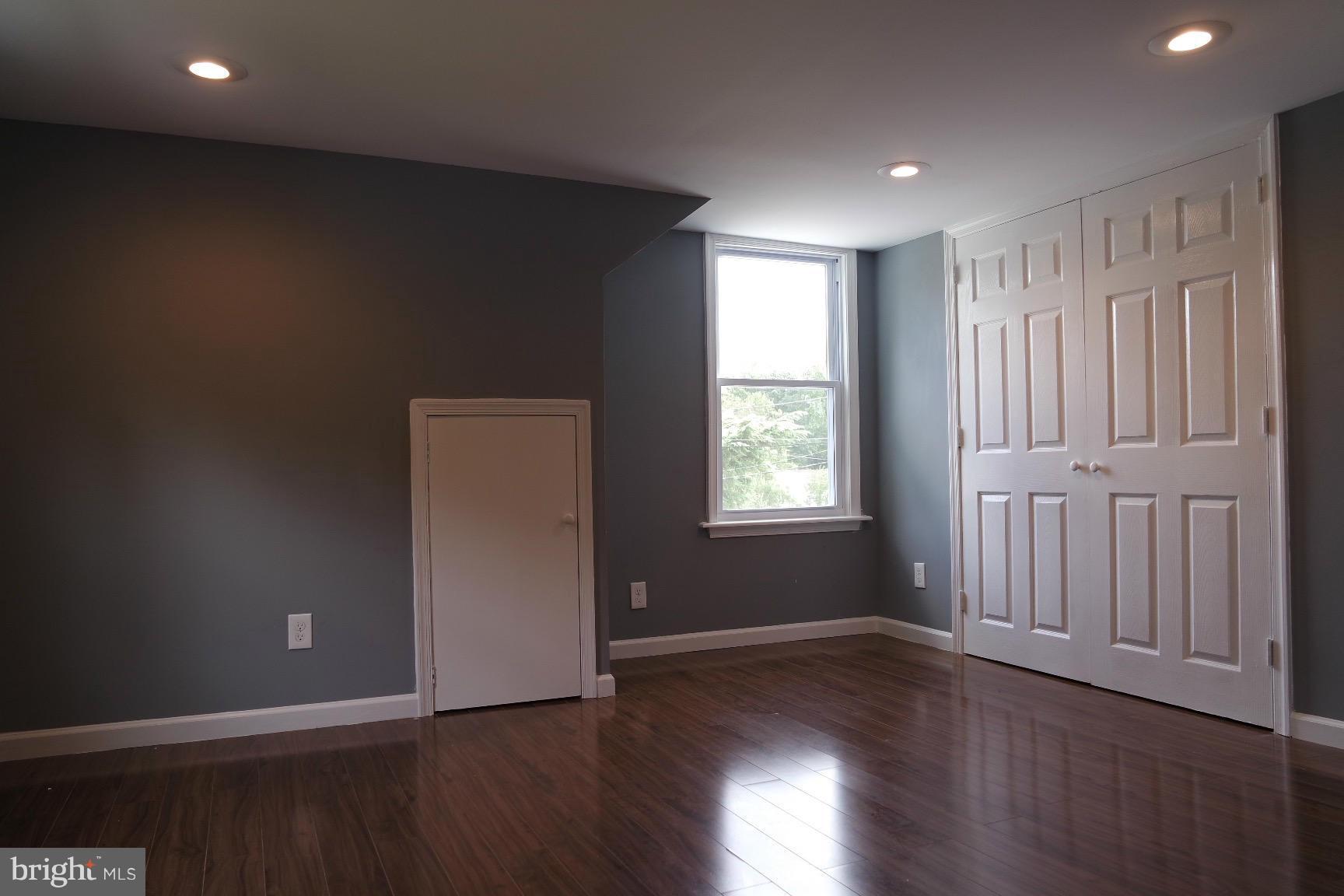6716 Larkspur Road Morningside, MD 20746 - Photo 17 of 23 an empty room with wooden floor and windows
