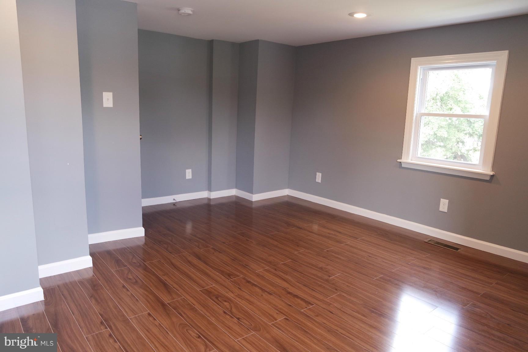 6716 Larkspur Road Morningside, MD 20746 - Photo 18 of 23 a view of wooden floor and windows in a room