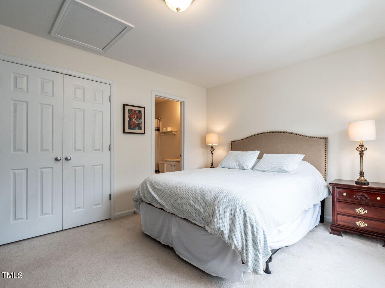 8349 City Loft Court Raleigh, NC 27613 - Photo 18 of 24 a bedroom with a bed and a night stand