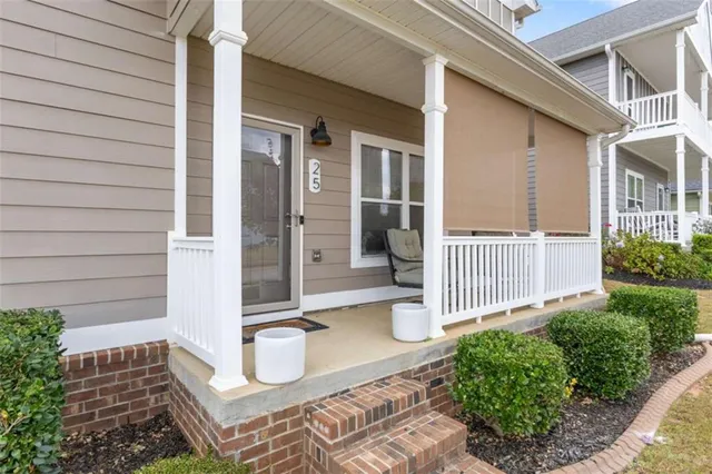 a kitchen with stainless steel appliances granite countertop a dining table chairs refrigerator and microwave