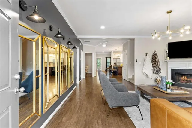 a kitchen with stainless steel appliances granite countertop a sink a stove and a wooden floors