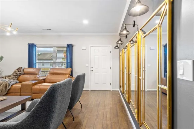 a view of dining room and kitchen with furniture wooden floor and chandelier