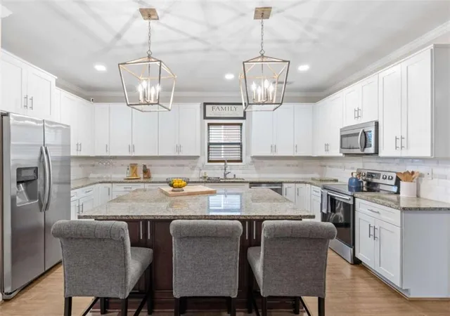 a dining room with a wooden table and chairs