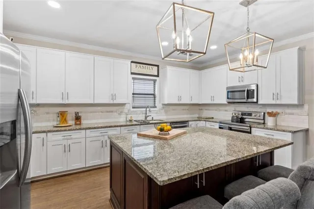 a bedroom with a large bed and a chandelier