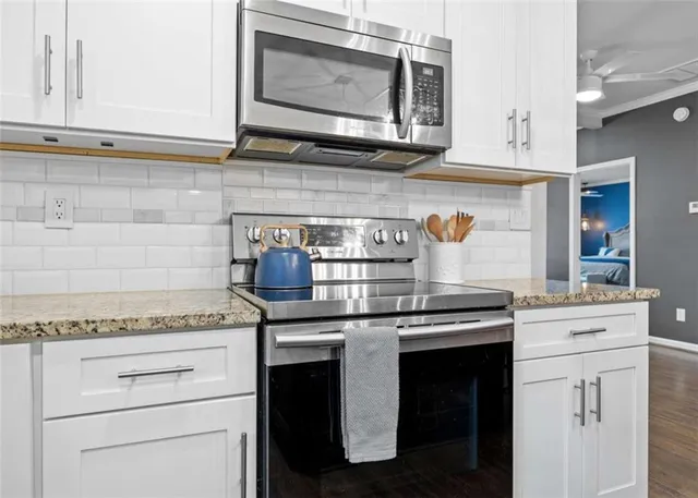 a en suite bathroom with a granite countertop sink mirror and vanity
