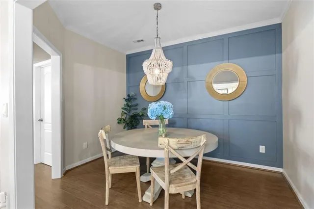 a living room with furniture a fireplace and a chandelier