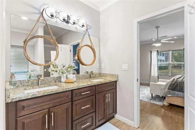 a bathroom with a granite countertop sink toilet a mirror and shower