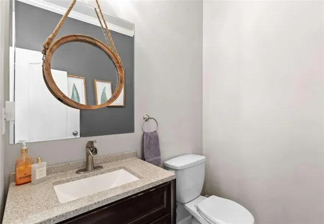 a bathroom with a sink a toilet and shower curtain