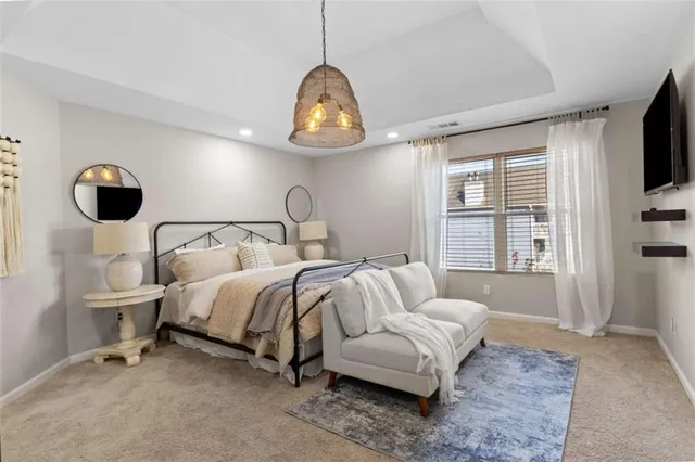 a living room with furniture a flat screen tv and a window