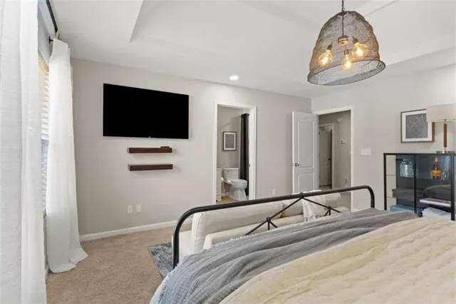 a bedroom with furniture and a chandelier