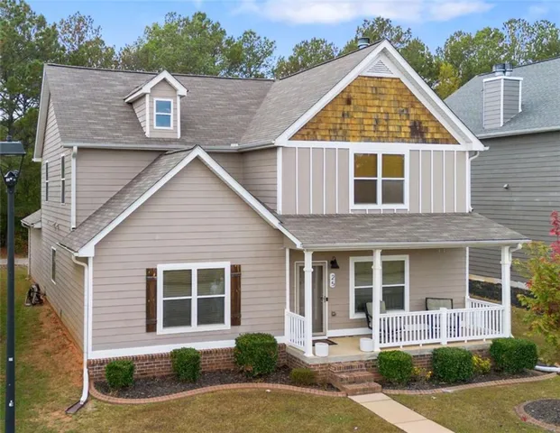 a backyard of a house with deck and furniture