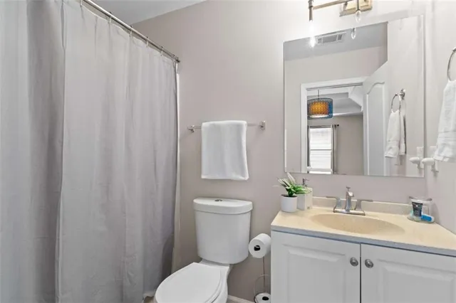 an aerial view of a house with a yard and mountains