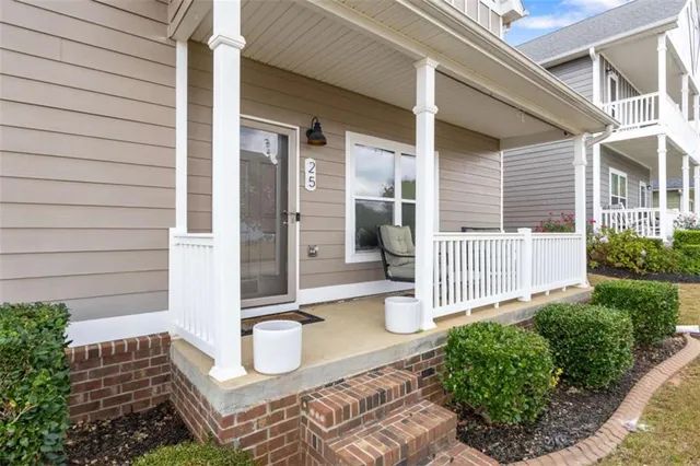 a living room with furniture kitchen view and a chandelier
