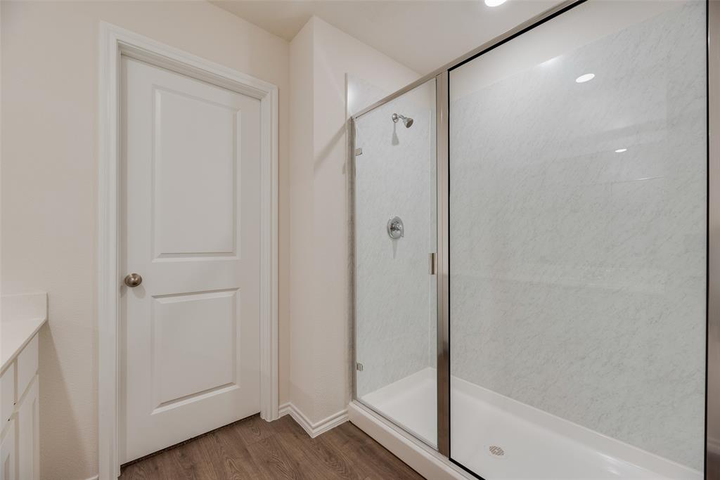 3407 Rendezvous Way Sherman, TX 75090 - Photo 15 of 17 Walk-in shower featuring a glass enclosure and white patterned surround