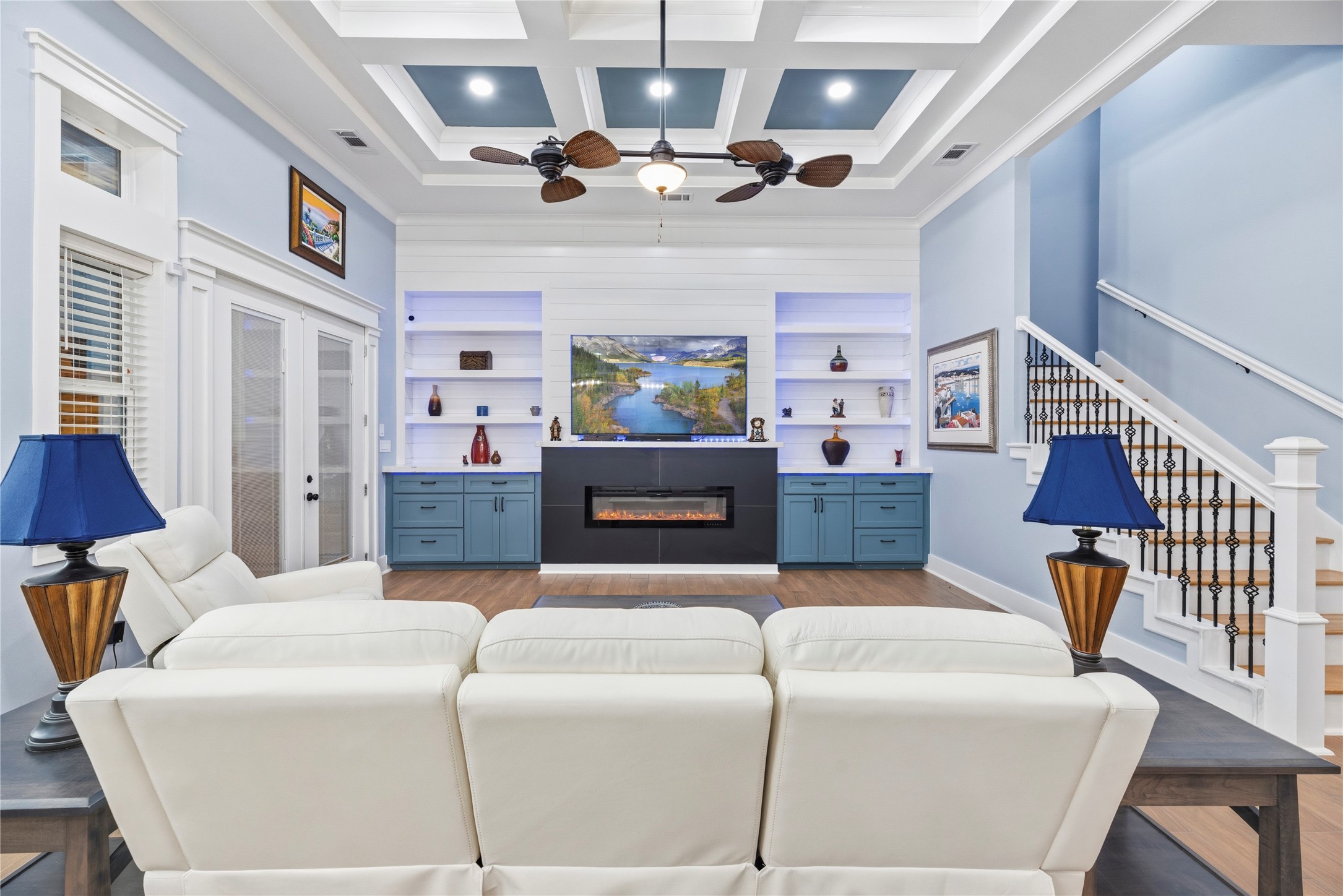 4607 Clayhead Road Richmond, TX 77406 - Photo 19 of 50 Family room highlighted by soaring coffered ceilings, custom built-ins, and a sleek linear fireplace designed for sophisticated comfort.