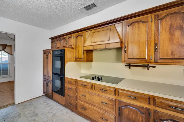 a kitchen with cabinets and appliances