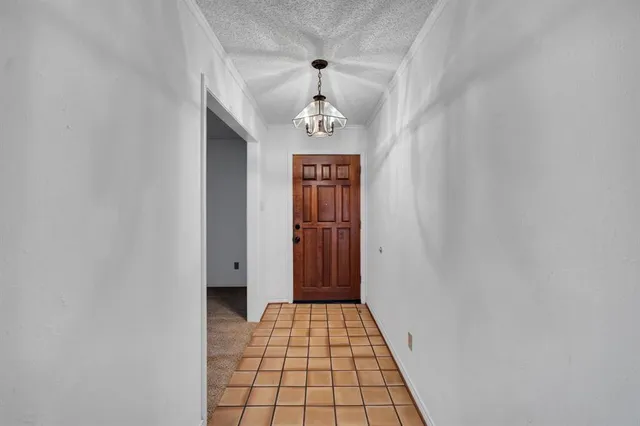 a view of hallway with wooden floor