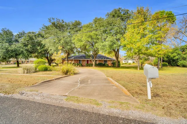 a sign board with yard in the back