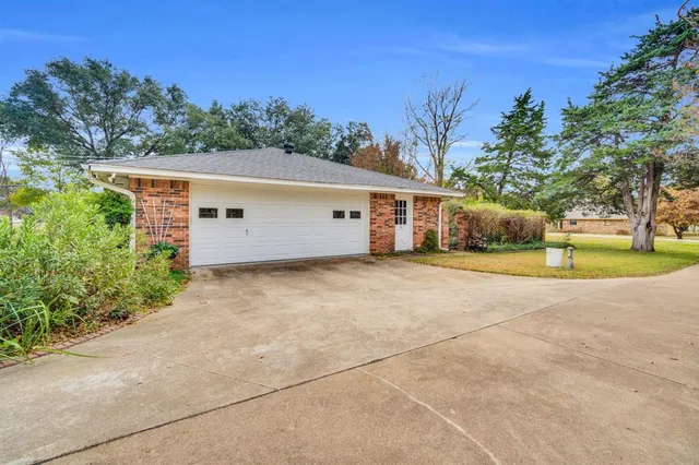 a view of a house with a yard and tree s