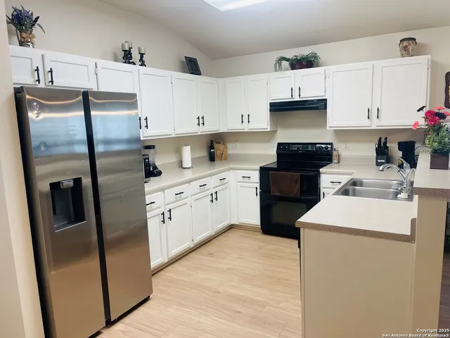 a kitchen with cabinets and stainless steel appliances
