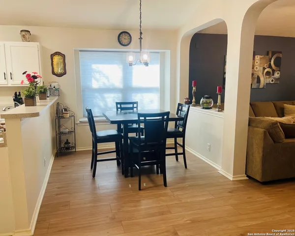 a view of a dining room with furniture and chandelier
