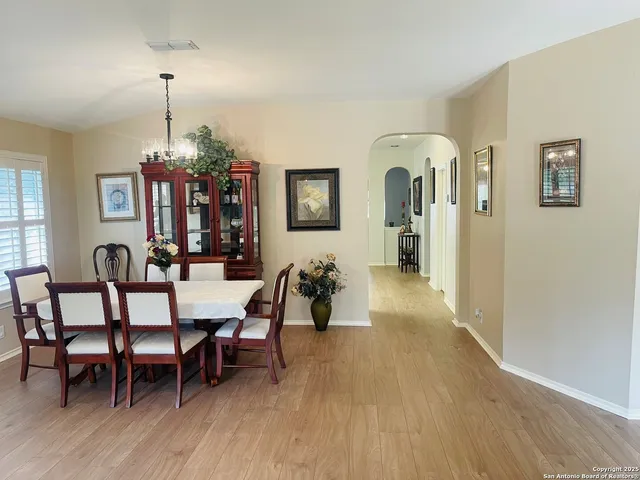 a dining room with furniture window and wooden floor