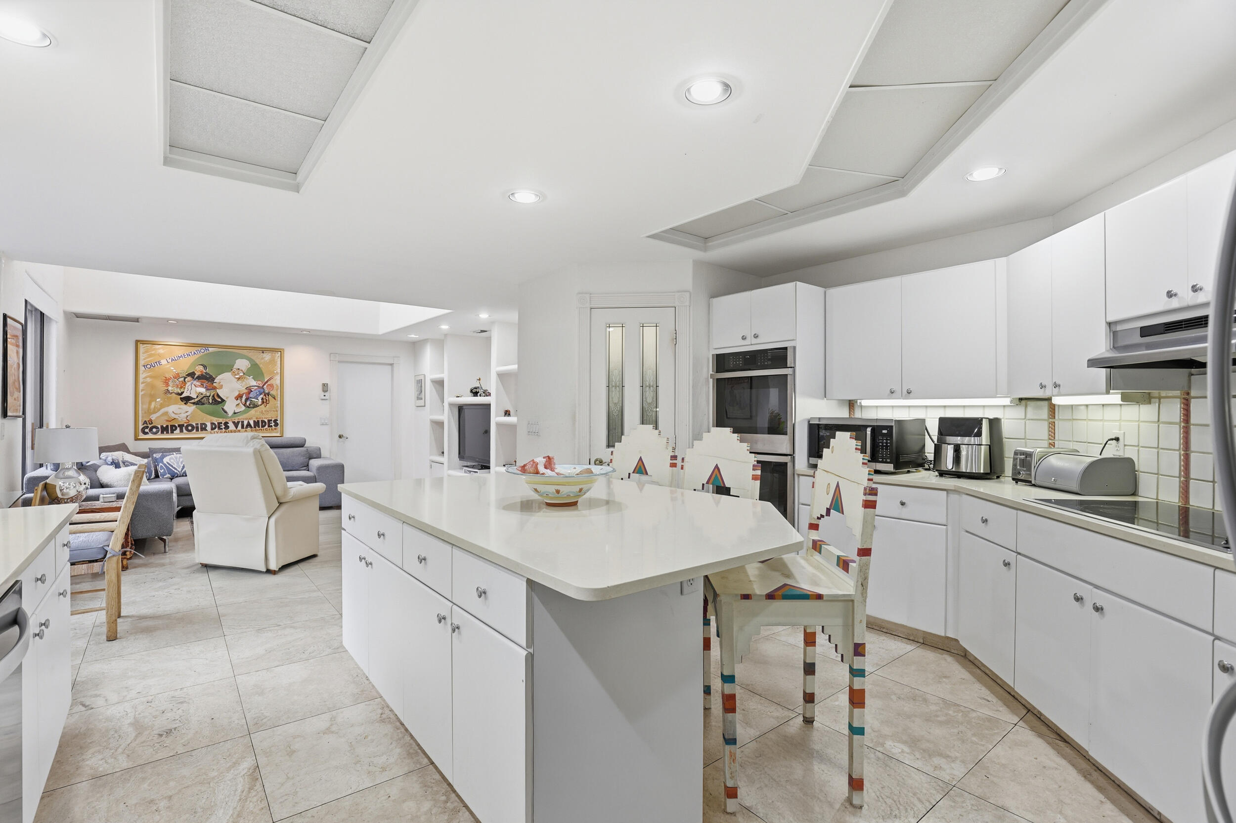 2248 Northwest 60th Street Boca Raton, FL 33496 - Photo 16 of 70 a kitchen with white cabinets sink and stove