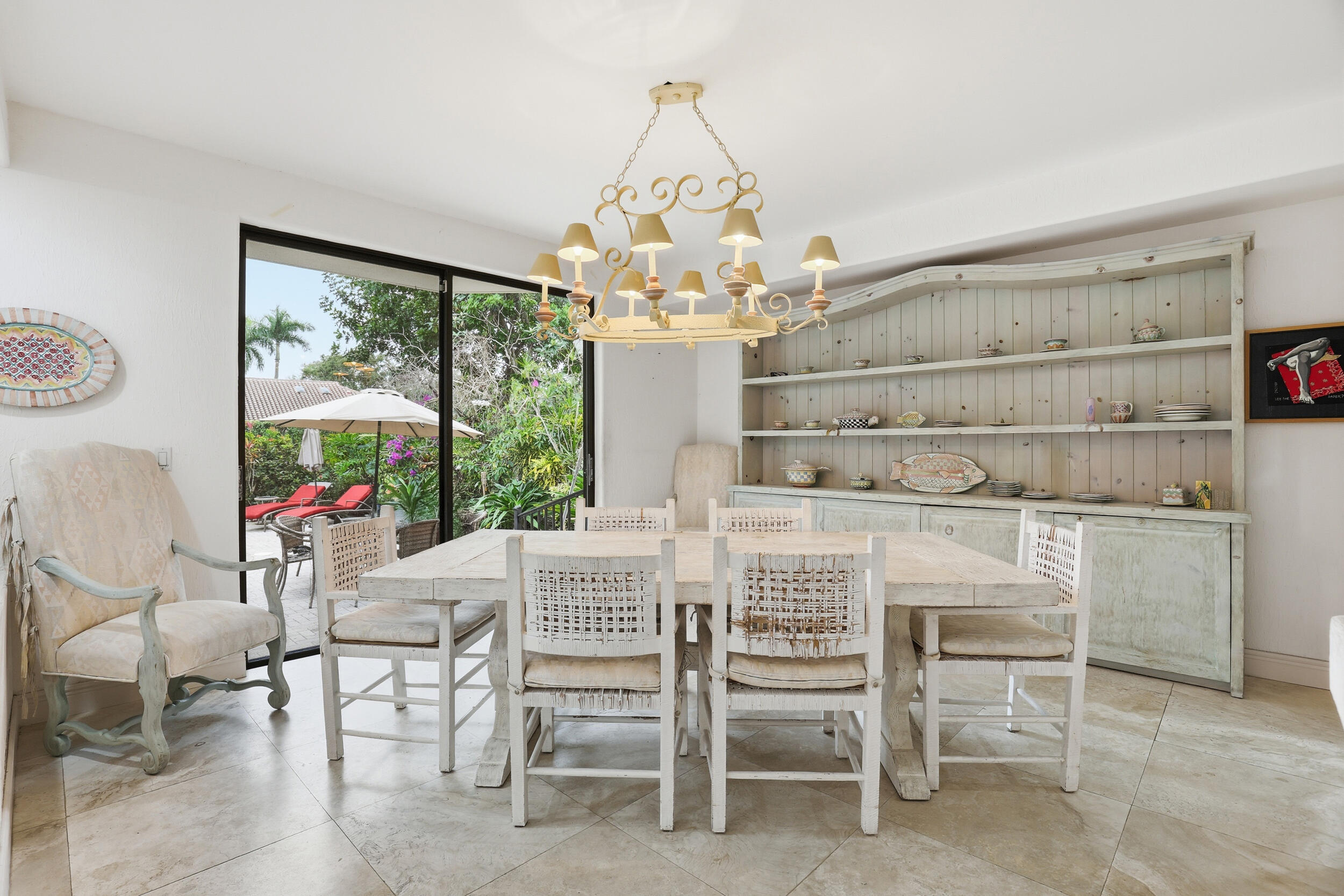 2248 Northwest 60th Street Boca Raton, FL 33496 - Photo 20 of 70 a dining room with furniture a large window and a chandelier