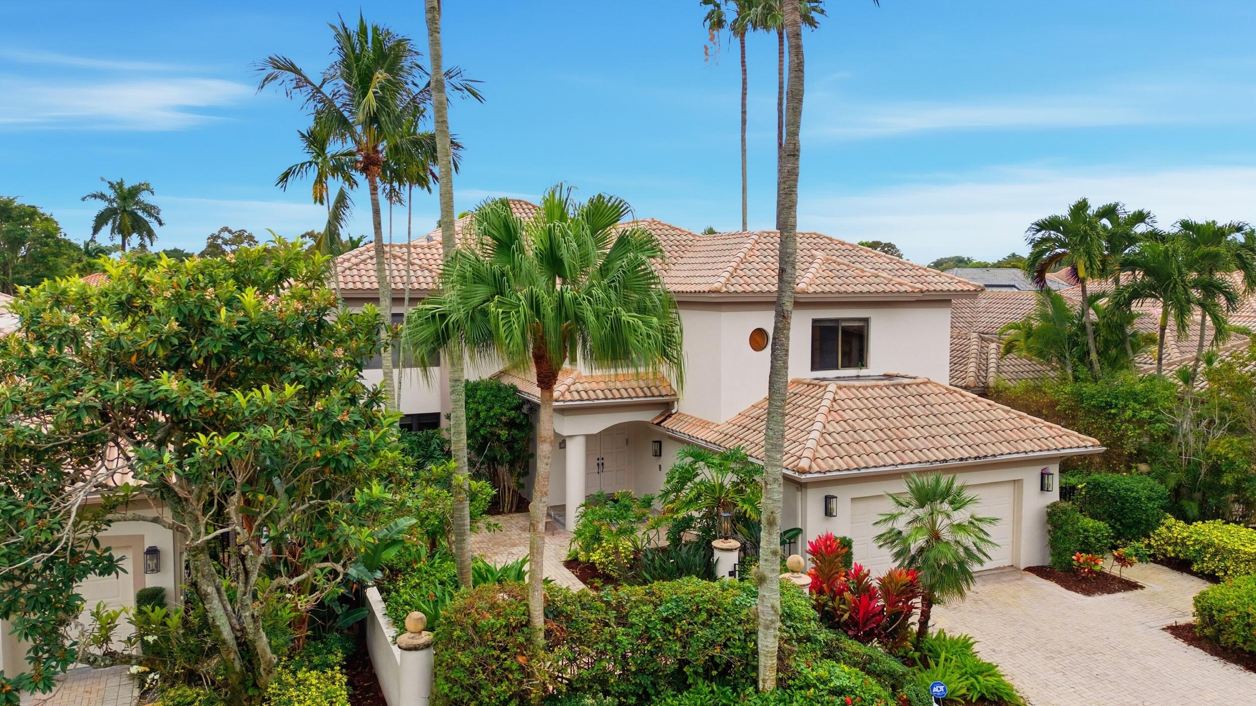 2248 Northwest 60th Street Boca Raton, FL 33496 - Photo 2 of 70 a view of a house with a fountain and potted plants