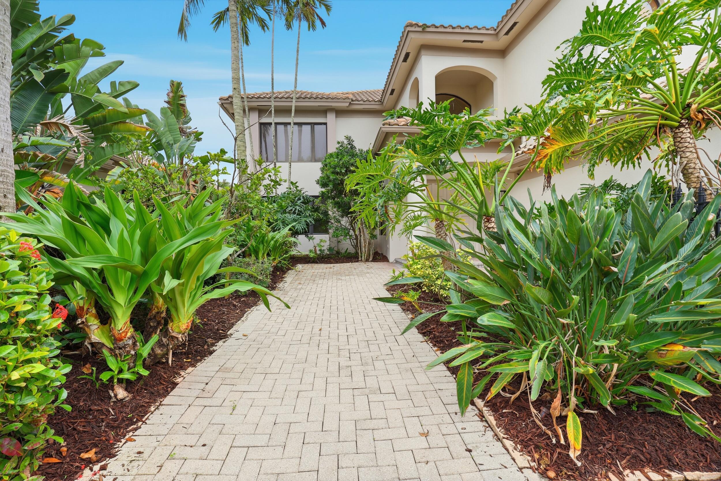 2248 Northwest 60th Street Boca Raton, FL 33496 - Photo 4 of 70 a front view of a house with a yard and plant